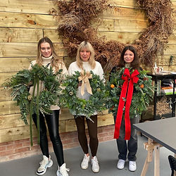 Three Workshop attendees with their wreathes
