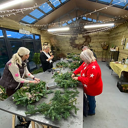 Workshop attendees making their Christmas wreathes in the studio