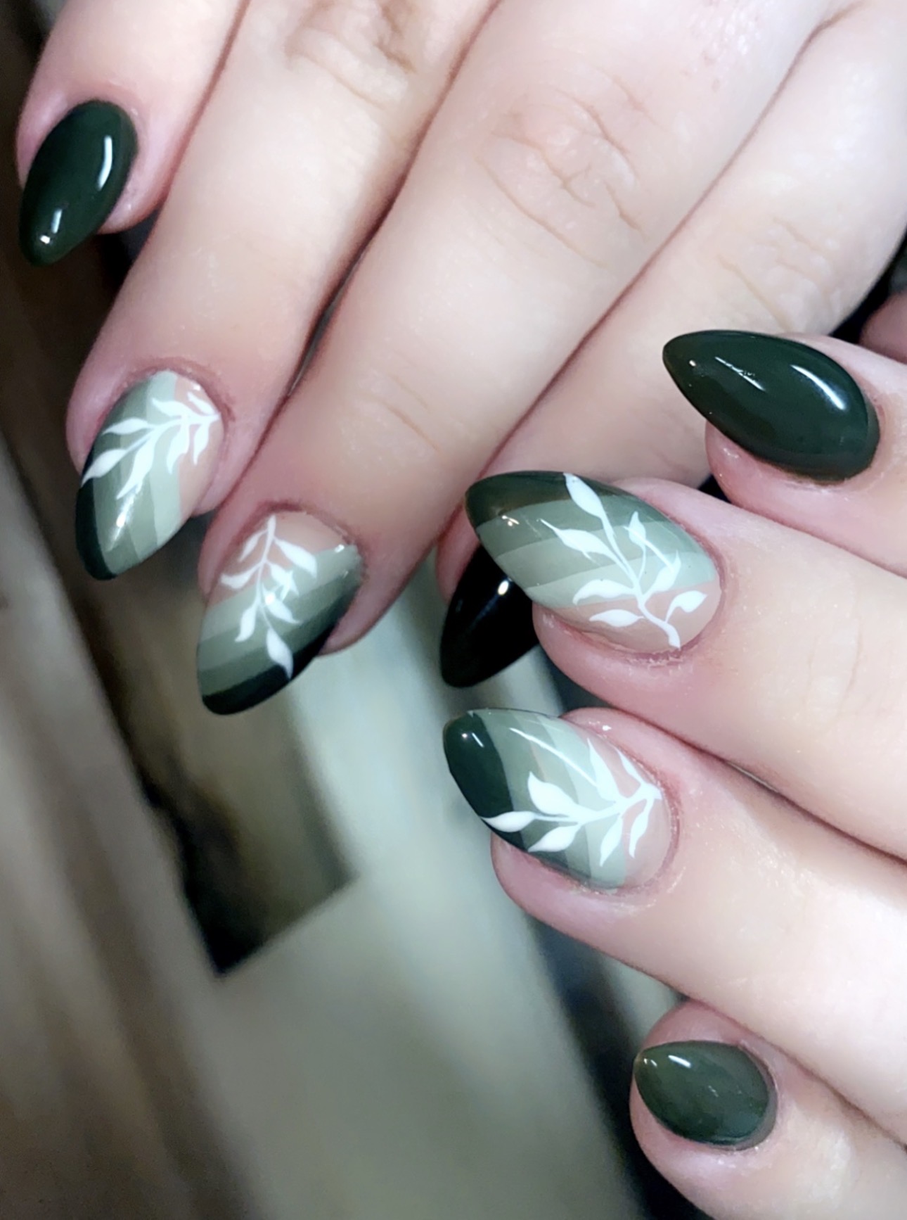 Forest green nails with white leaves by Sherry Ball