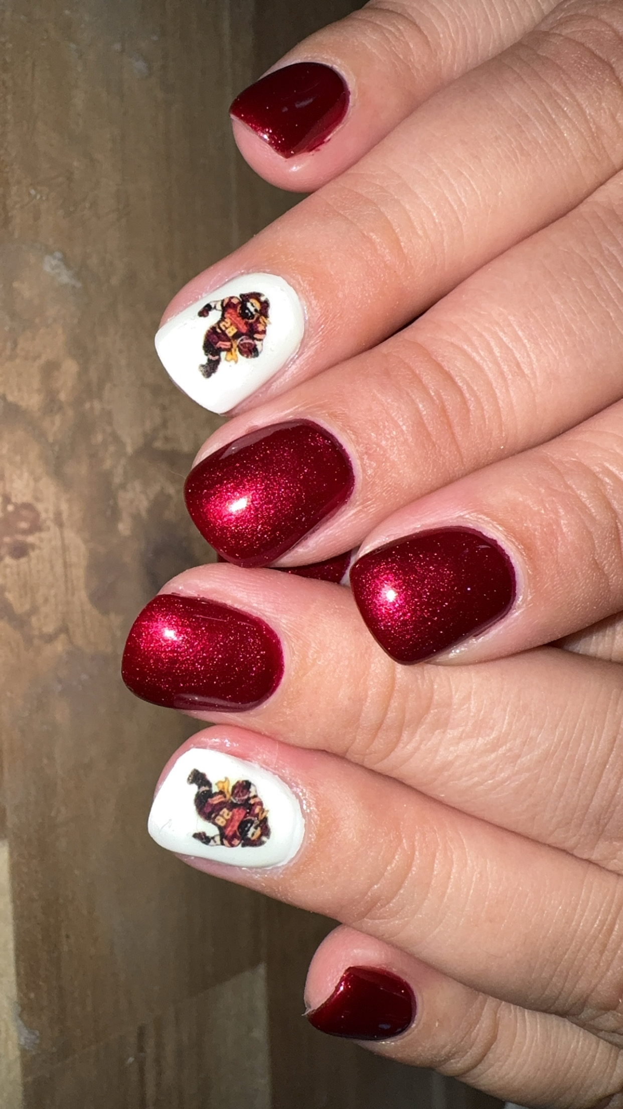Burgundy shimmer nails with football accents by Sherry Ball
