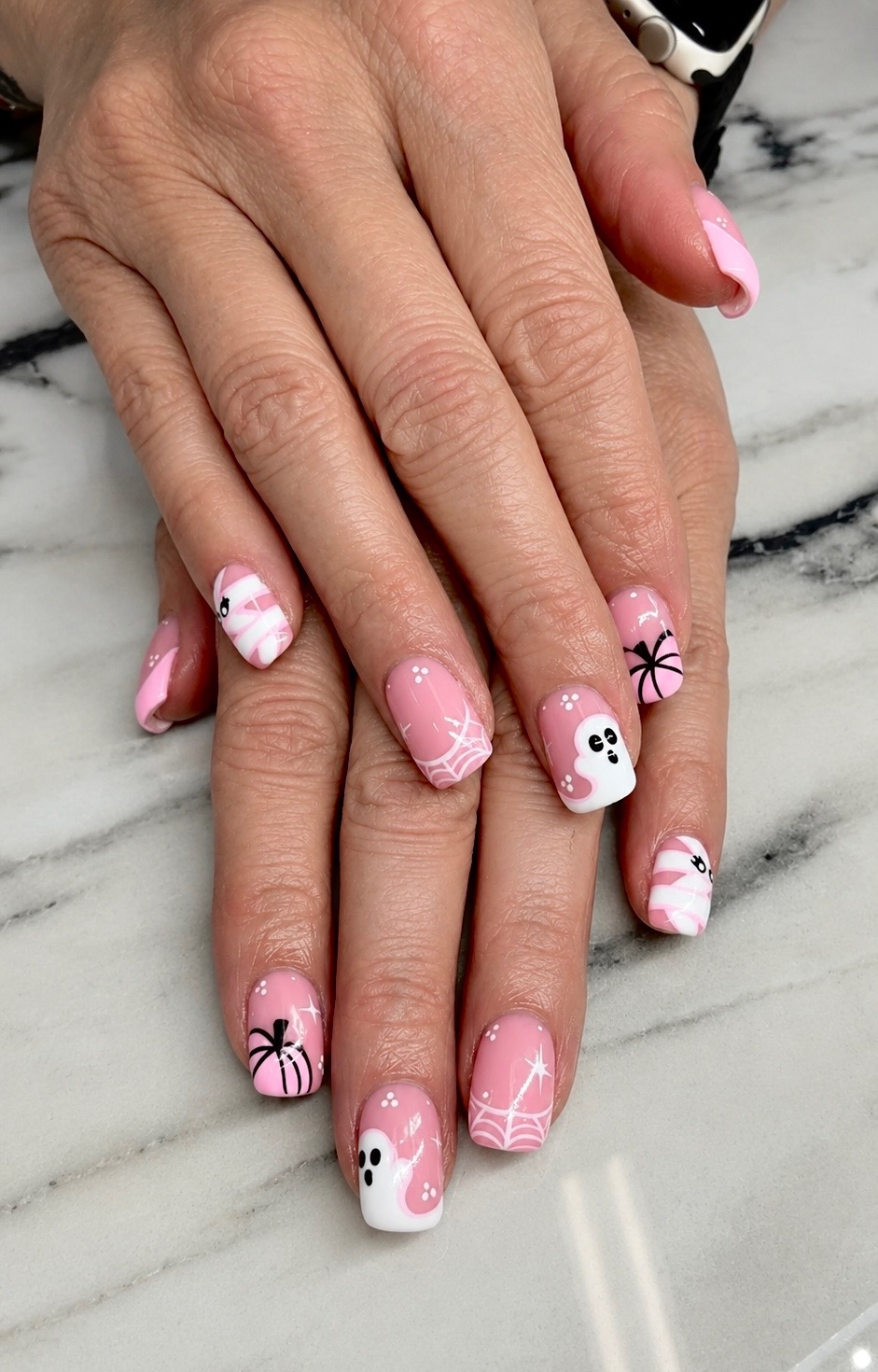 Pink Halloween nails with ghosts and spiderwebs by Tiffany Campbell