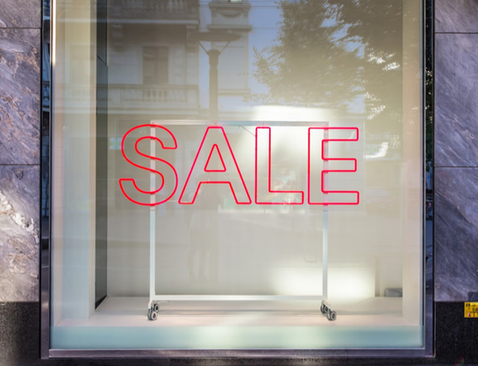 Слово Sale на вітрині магазину