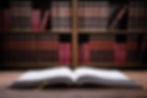 Close-up Of An Open Law Book On Wooden Desk In Courtroom.jpg