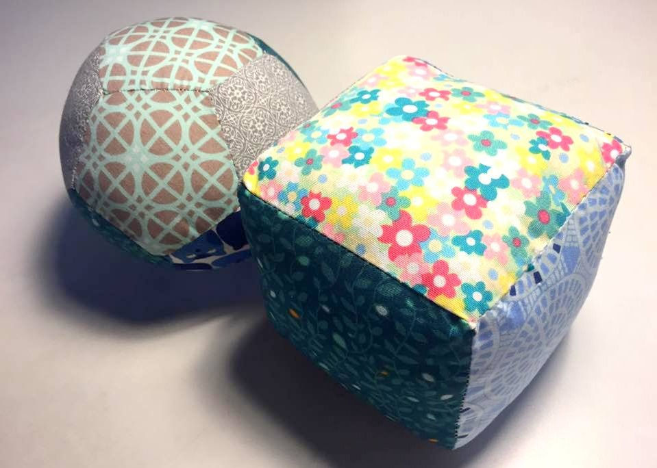 Fabric patchwork cube and fabric patchwork ball.