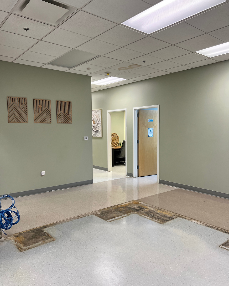 Photo of NAMI Richland County’s main office space after the old reception desk was removed, showing the cleared area ready for renovation.