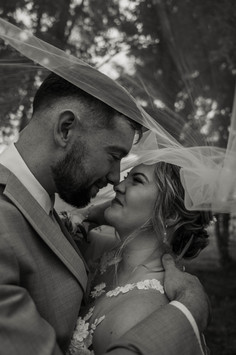 couples portraits on their wedding day in a field of grasses