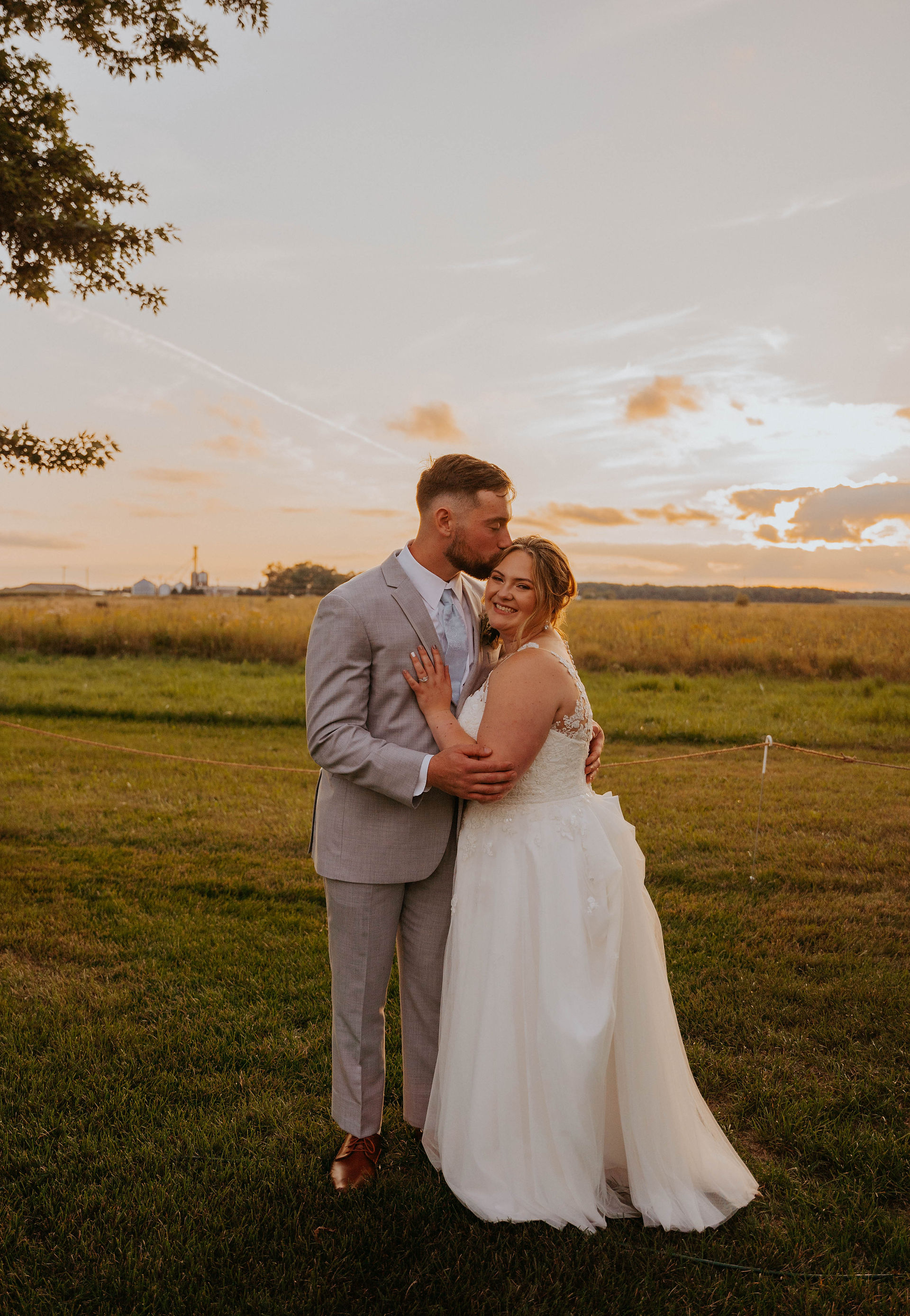 couples portraits on their wedding day in a field of grasses