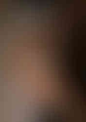 a couple taking photos downtown with very tall cream colored buildings