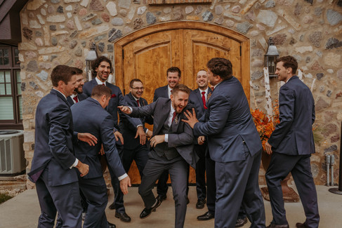 bridal party in red and blue celebrating the couples special day in group photos