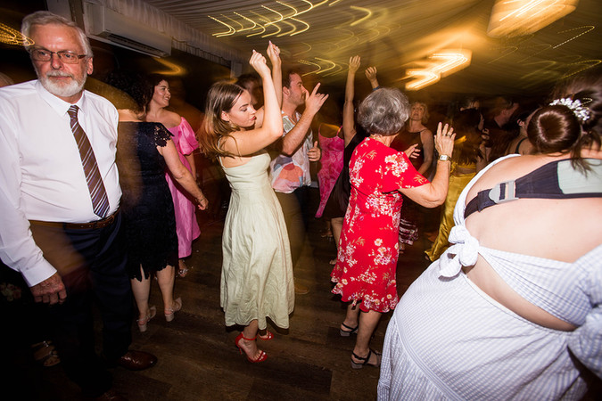 guests dance at a wedding reception with light trails