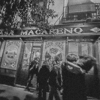 Buddies swirling out of a quant Spanish bar post-Vermouth consumptions...