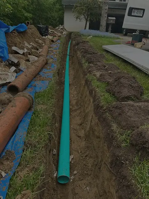 Excavated clay drain pipes beside a newly installed replacement pipe during professional drain repair in Toronto