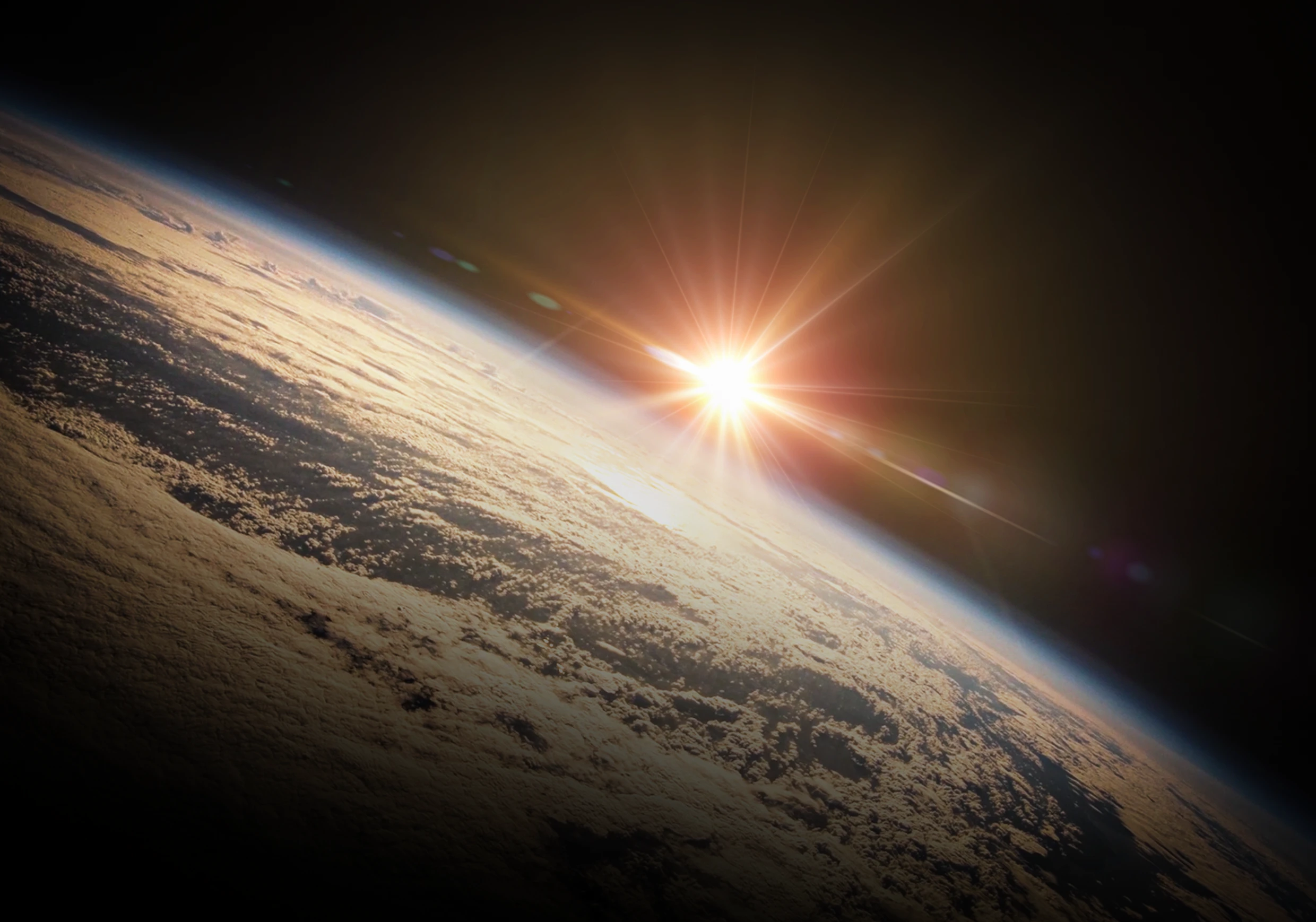 Earth from space with the Sun shining above mottled clouds