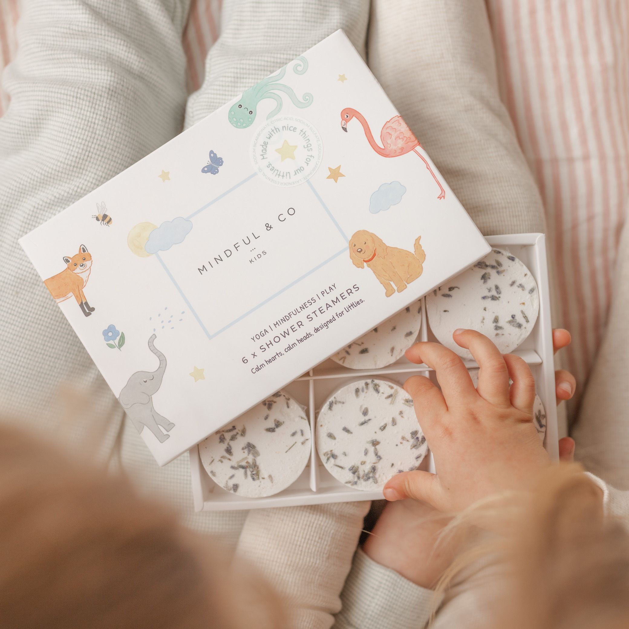 Child with shower steamers on their lap