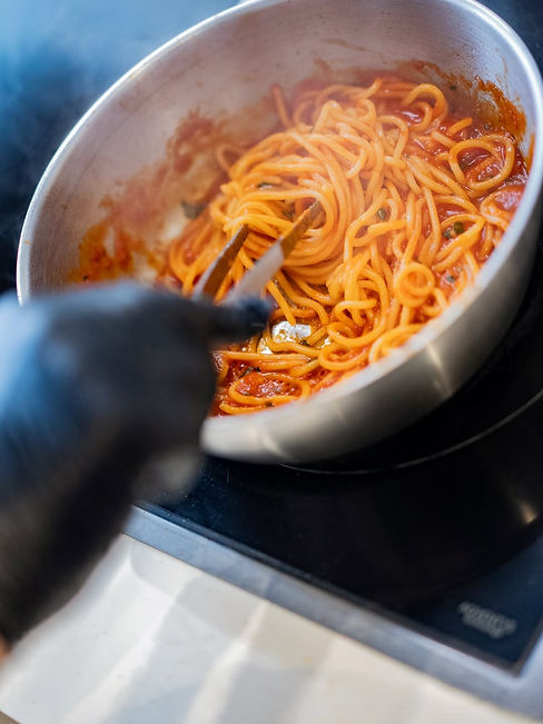 Fresh pasta tossed in tomato sauce by hand at Mìzzica Italian restaurant in Brussels