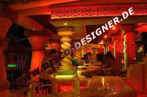 Garden gazebo, made of natural stone and wood with a green color roof, decorated in the style of ancient Egyptian. The top is shaped like an ornamented dome, adorned with lotus-shaped patterns.