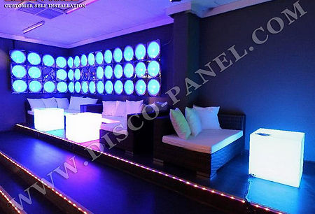 This decade light panels are LED panel wall decorations for night clubs and disco bars. It shows customer installation of LED lights on a frame for a night view. There is a white LED display panel in a room with blue light. A seating area has sofas with bright colored pillows. The night scene of a club lounge shows a wall decorated with LED panels. Another wall is covered with square LED panels for wall decoration.