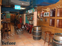 before and after photo of the interior decoration, old wood barrel wall in western bar with red seats and tables, blue ceiling.