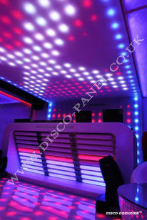 Photo showcasing DJ Light Studio in action at a nightclub. The DJ booth is highlighted with multi-colored LED lights controlled by our DMX Software, enhancing the visual experience for club-goers.