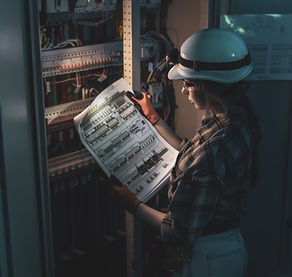 female-electrical-engineer-checking-power-system-diagram-near-control-panel-engineering-in