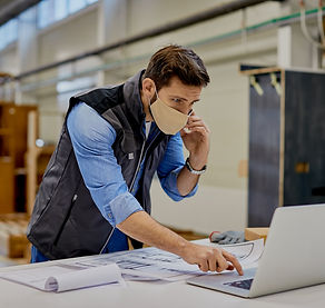 carpenter-woodworking-factory-using-laptop-while-communicating-cell-phone.jpg