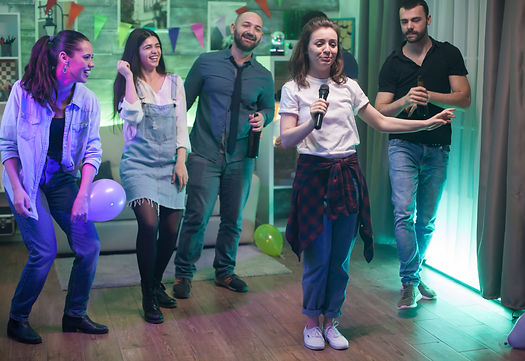 young-beautiful-woman-surrounded-by-her-friends-doing-karaoke-party.jpg