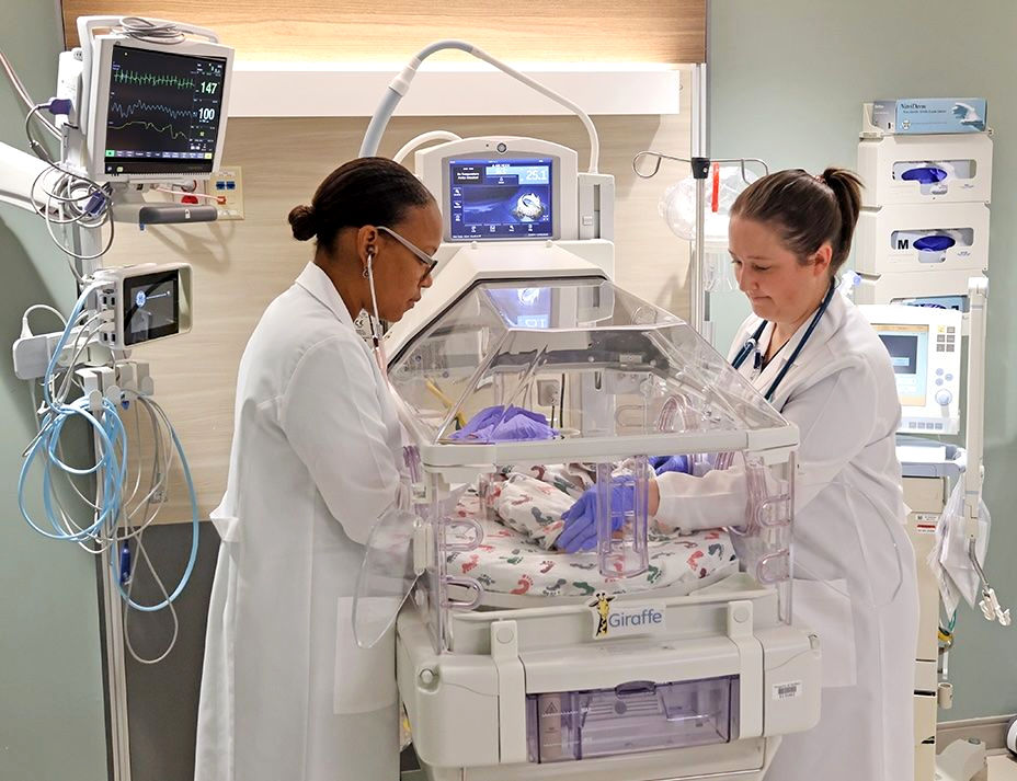 Neonatologists in the NICU caring for a newborn