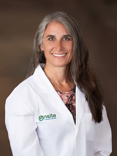 Dr. Connie Andrejko in clinical white coat