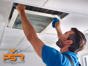 technician cleaning ceiling vent while dust is being removed from duct interior, bright Boca Raton home