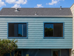residential roofing installation with modern shingles, clean roofline, bright daylight