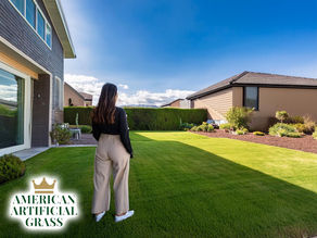 rental property with an inviting, neatly maintained artificial grass yard while a potential tenant admires the home’s outdoor appeal