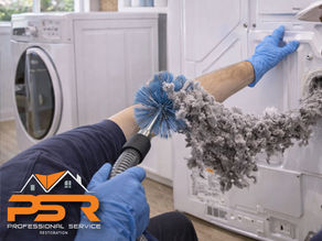 technician cleaning dryer vent behind laundry unit, lint being removed, Miami home interior