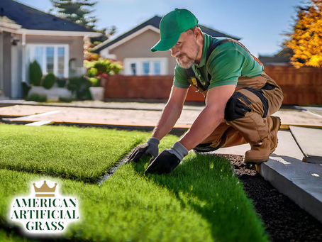 professional technician installing artificial grass lawn with concrete slab in front of residential property