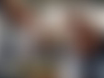 A worried homeowner looking at a sparking appliance with a technician ready to assist with professional appliance repair