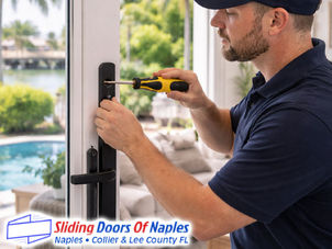 repair technician tightening sliding door lock hardware, Naples home interior view