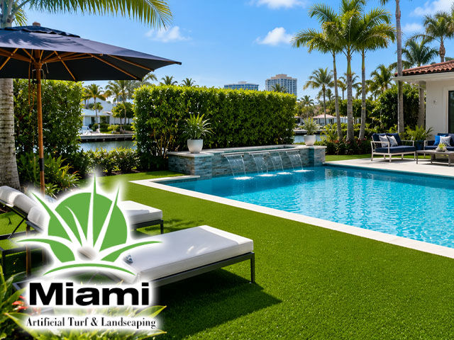 Luxury Miami swimming pool surrounded by lush synthetic grass, tropical landscaping, modern outdoor furniture, sunny South Florida setting