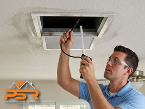 HVAC vent in ceiling with technician inspecting ducts for odor issues