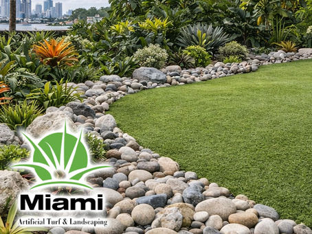 Miami backyard rock landscaping with decorative stones, rock border garden, synthetic grass lawn, tropical plants