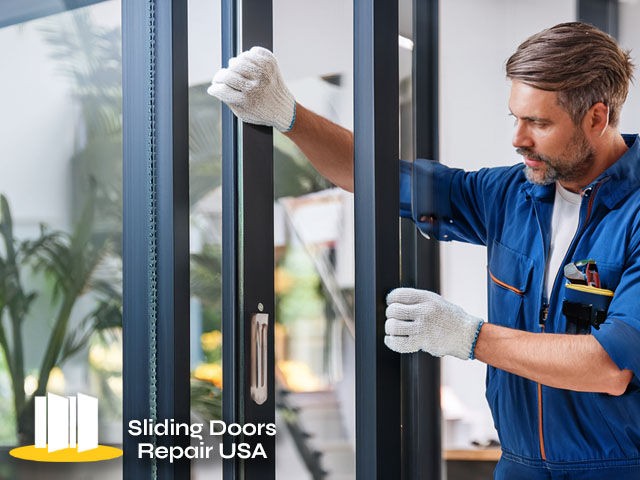 expert technician working on residential glass sliding door repairs