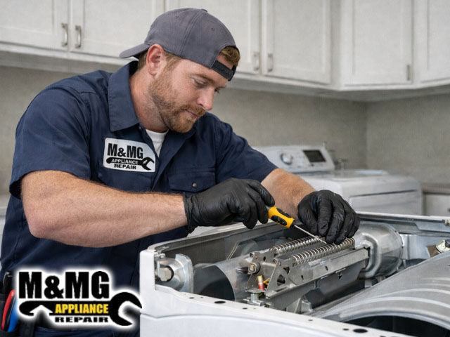 repair technician repairing dryer heating element in a modern laundry room