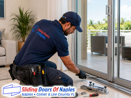 Professional sliding door technician repairing worn residential sliding glass door track, door panel partially open, repair technician using specialized track tools and alignment equipment
