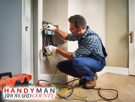professional handyman working on electrical repairs and installation interior of residential home broward county florida