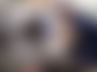 repair technician repairing front-load washer in a clean laundry room