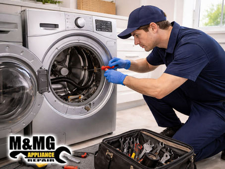 repair technician repairing front-load washer in a clean laundry room 