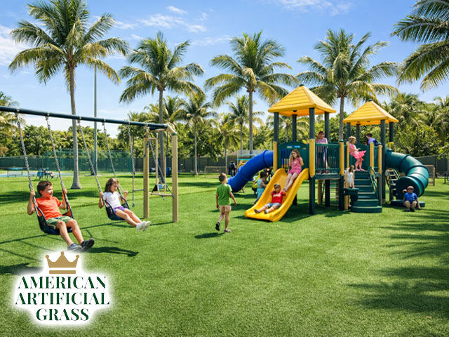 A bright playground area in Boca Raton covered with soft synthetic turf, kids playing on swings and slides, palm trees in the background