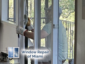 repair technician replacing small window lock mechanism with city skyline visible behind