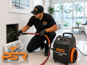 Professional technician cleaning residential air duct system inside Miami home, advanced duct cleaning equipment visible, clean indoor environment, bright South Florida setting