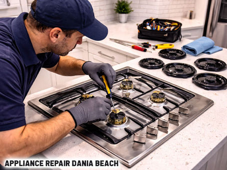 Technician repairing gas cooktop in a modern kitchen, with tools visible and burners exposed for inspection