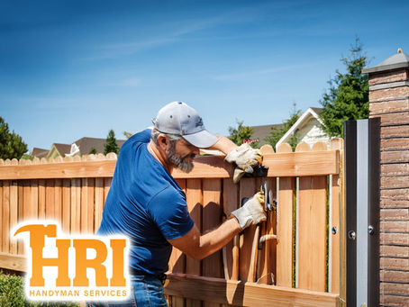 professional handyman technician working performing expert fence and gate repairs to residential property