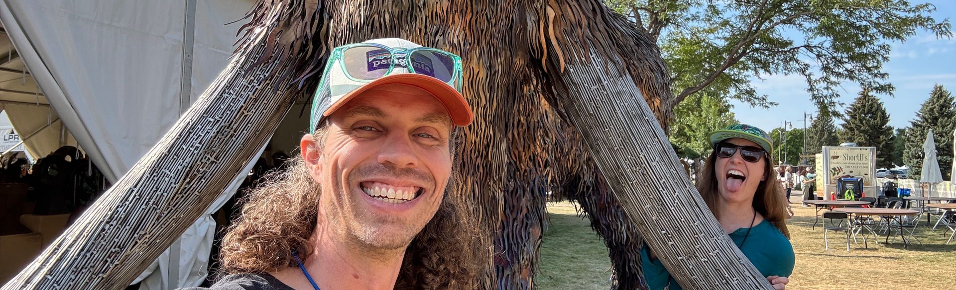 Rob at the 2025 Sculpture in the Park show, posing with Reborn (woolly mammoth) by artist Clinton Lesh.
